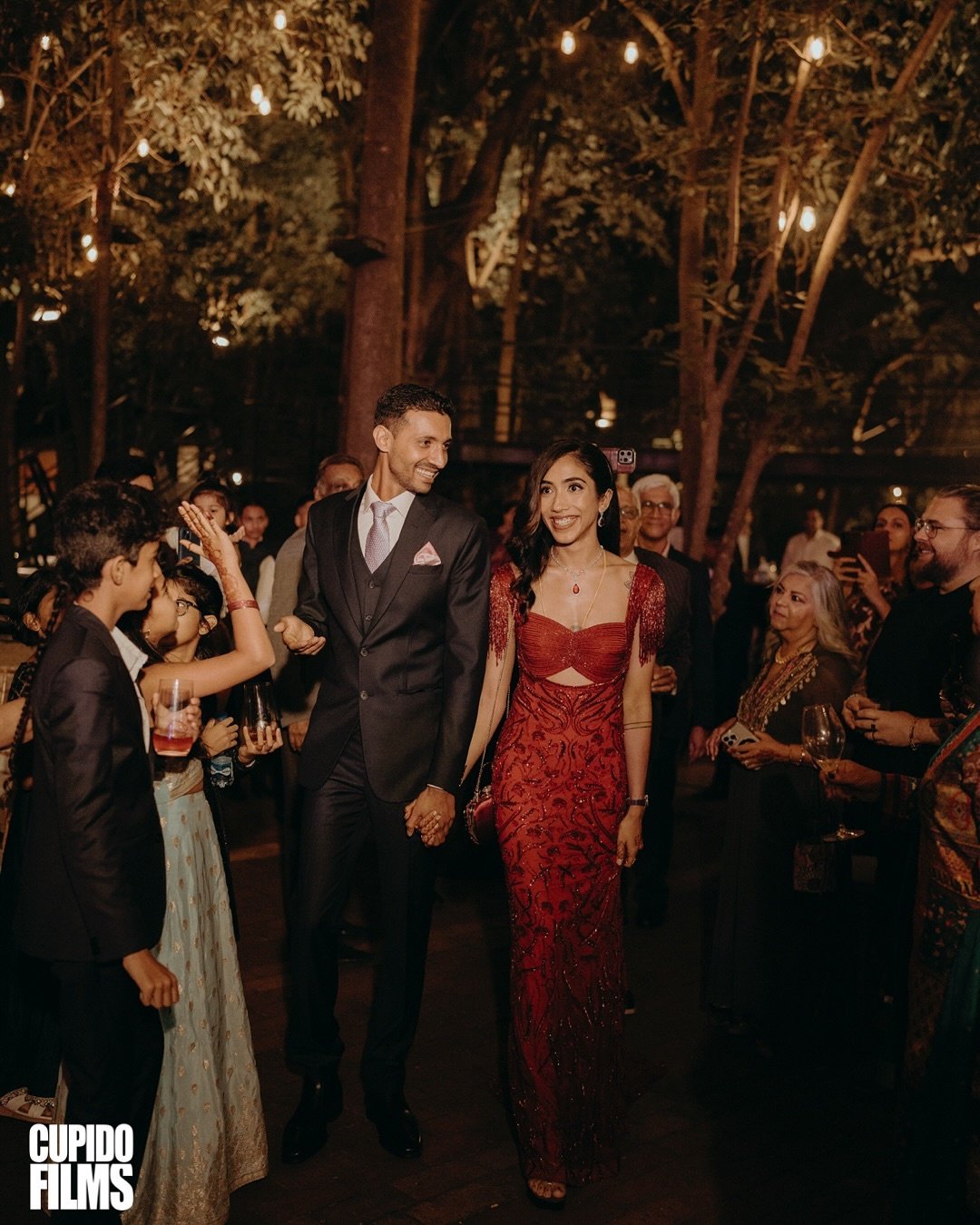 A couple entering their celebration hand in hand