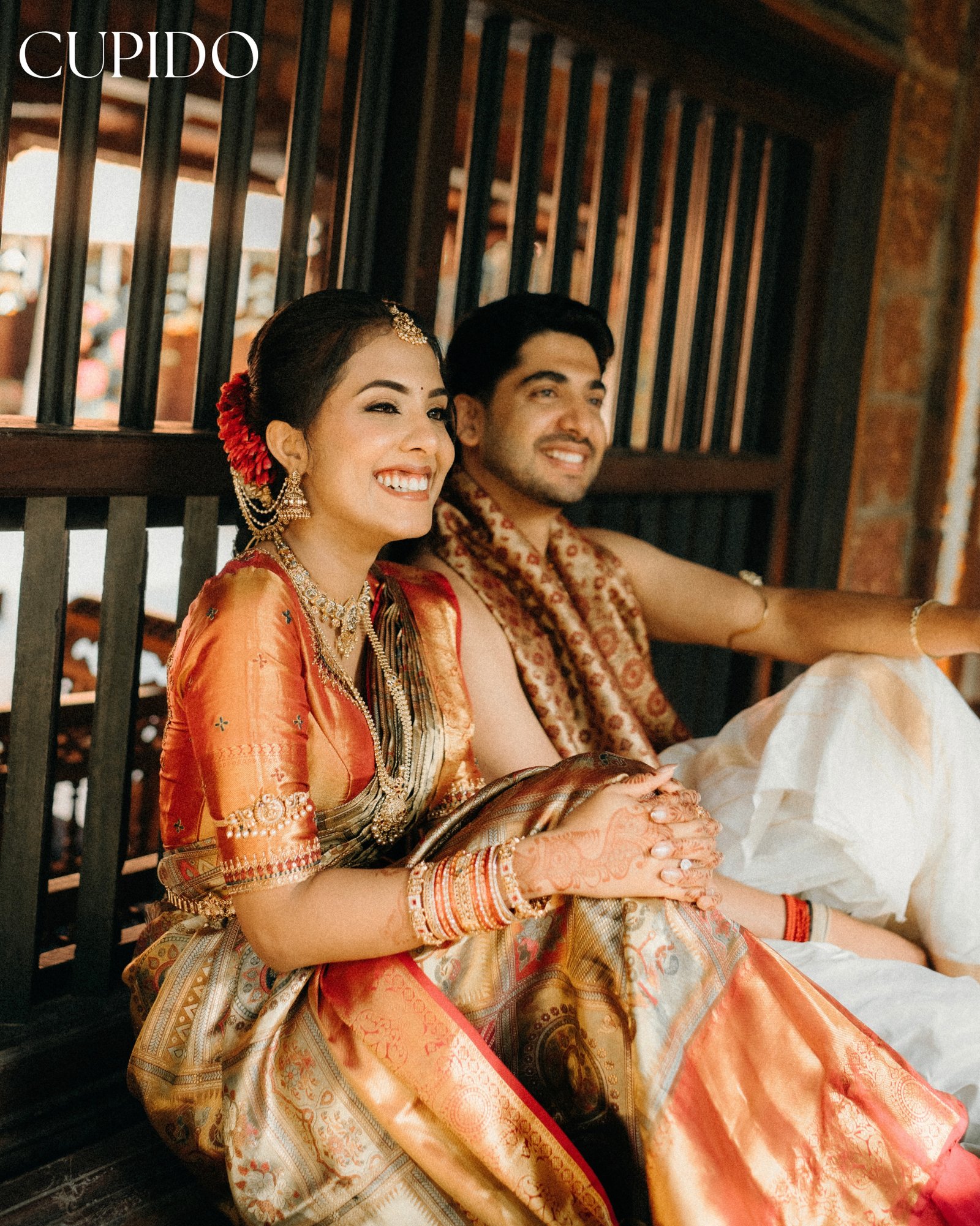 A smiling wedding couple in traditional attire
