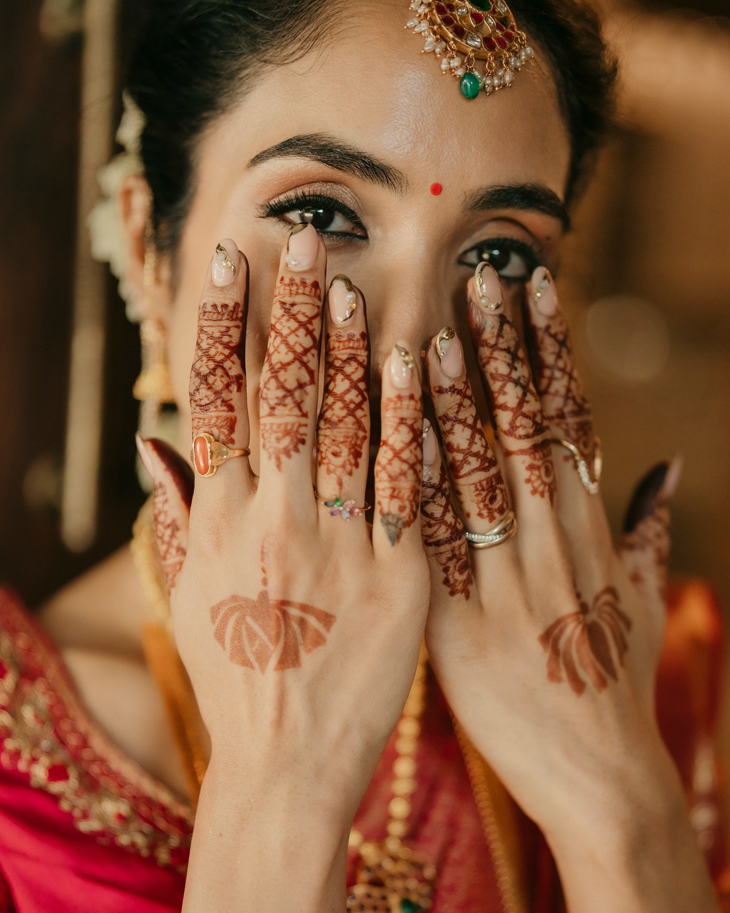 A bride showing her wedding mehndi and jewellery